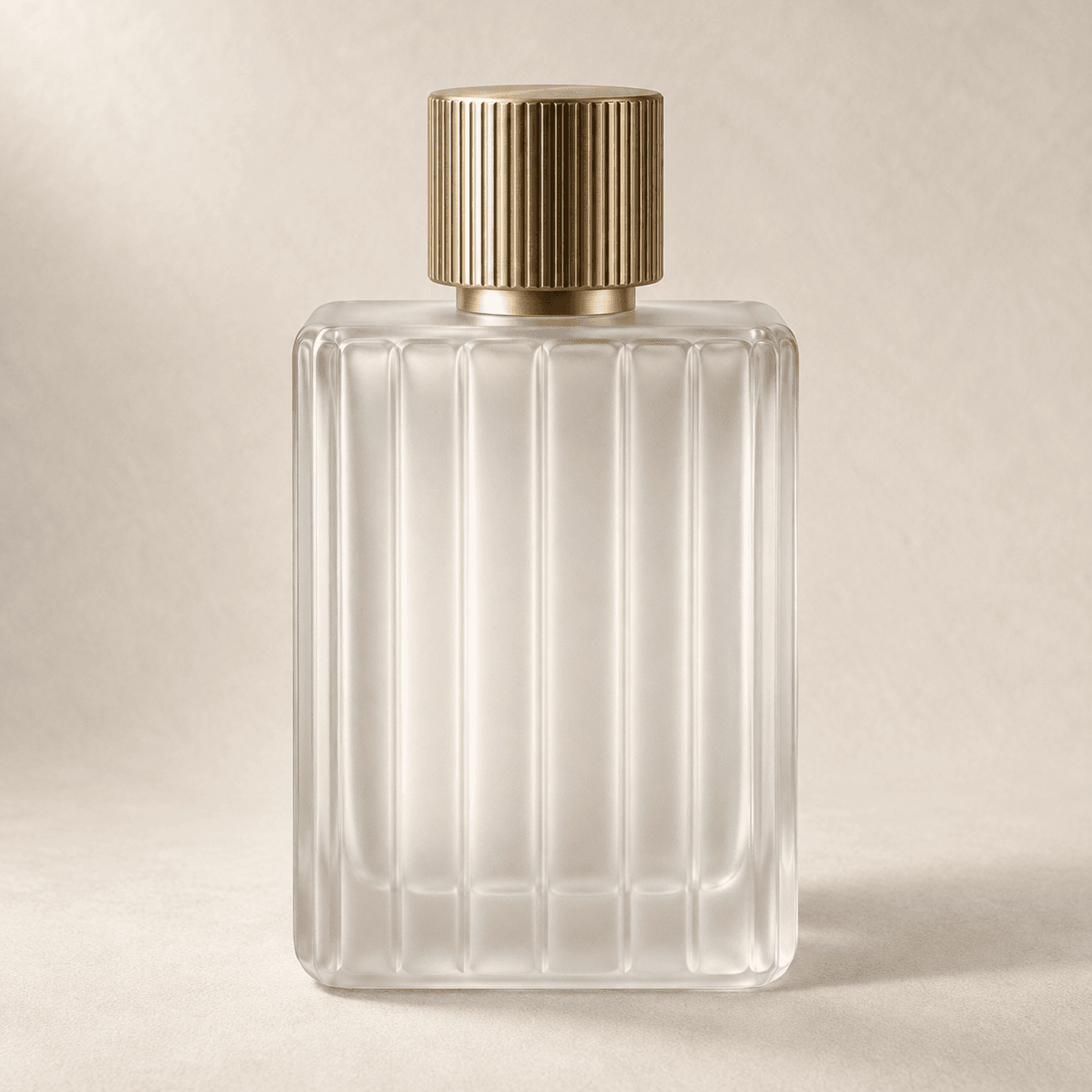 Frosted glass fragrance bottle with a brushed brass cap